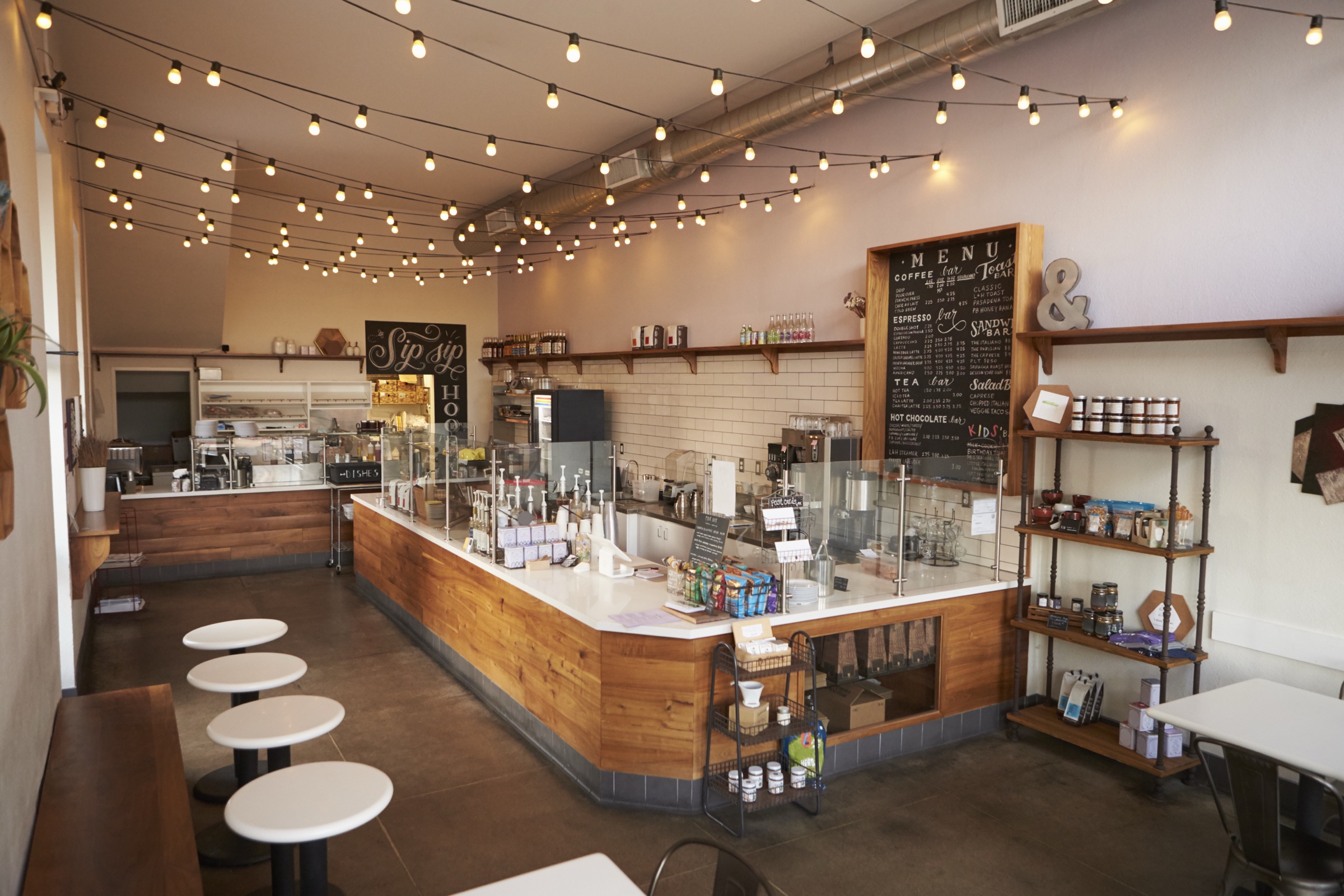 Finished coffee shop interior with wood counters and string lights in Charlotte, North Carolina